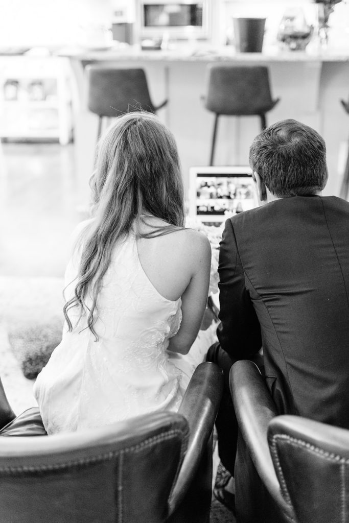 The bride and groom visit with their friends and family who are watching via a live-stream. 