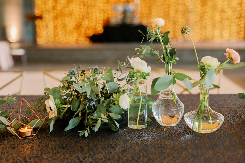Simple floral arrangements in industrial containers. 